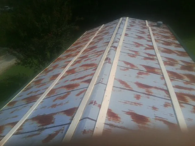 Rusted metal roof panels with new wood purlins before replacement — Storm Damage Roof Repair in Laguna by Roofing Brothers