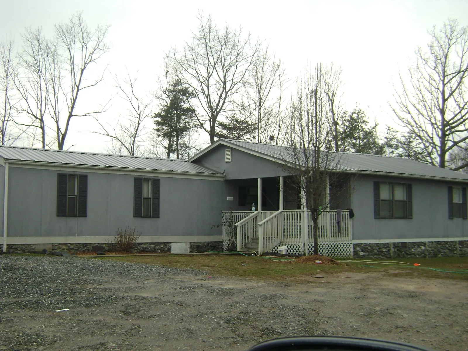 Metal roof over a manufactured home with a covered front porch in Laguna