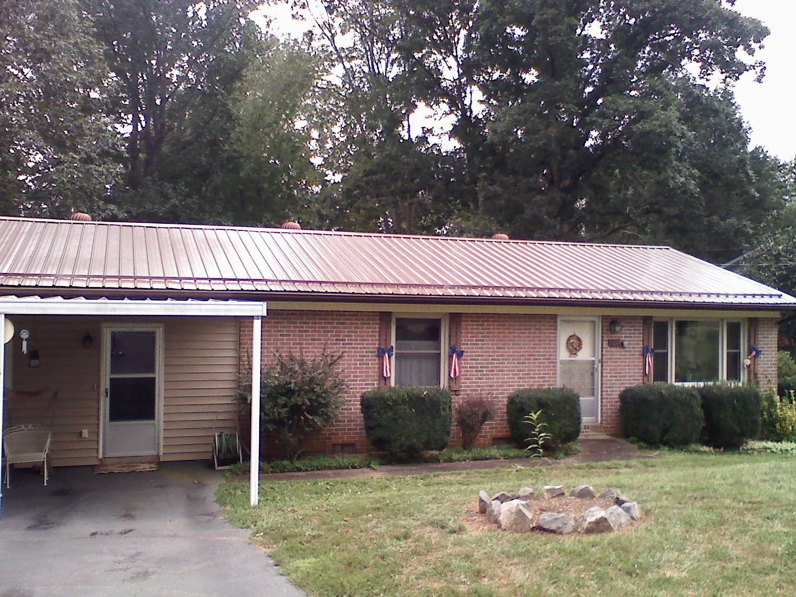 Bronze metal roof and carport on a brick ranch home — Roof Repair work by our crew in Laguna